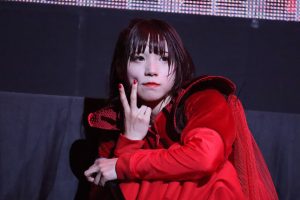 AYUNi D in red costume during the live in Osaka Jo Hall